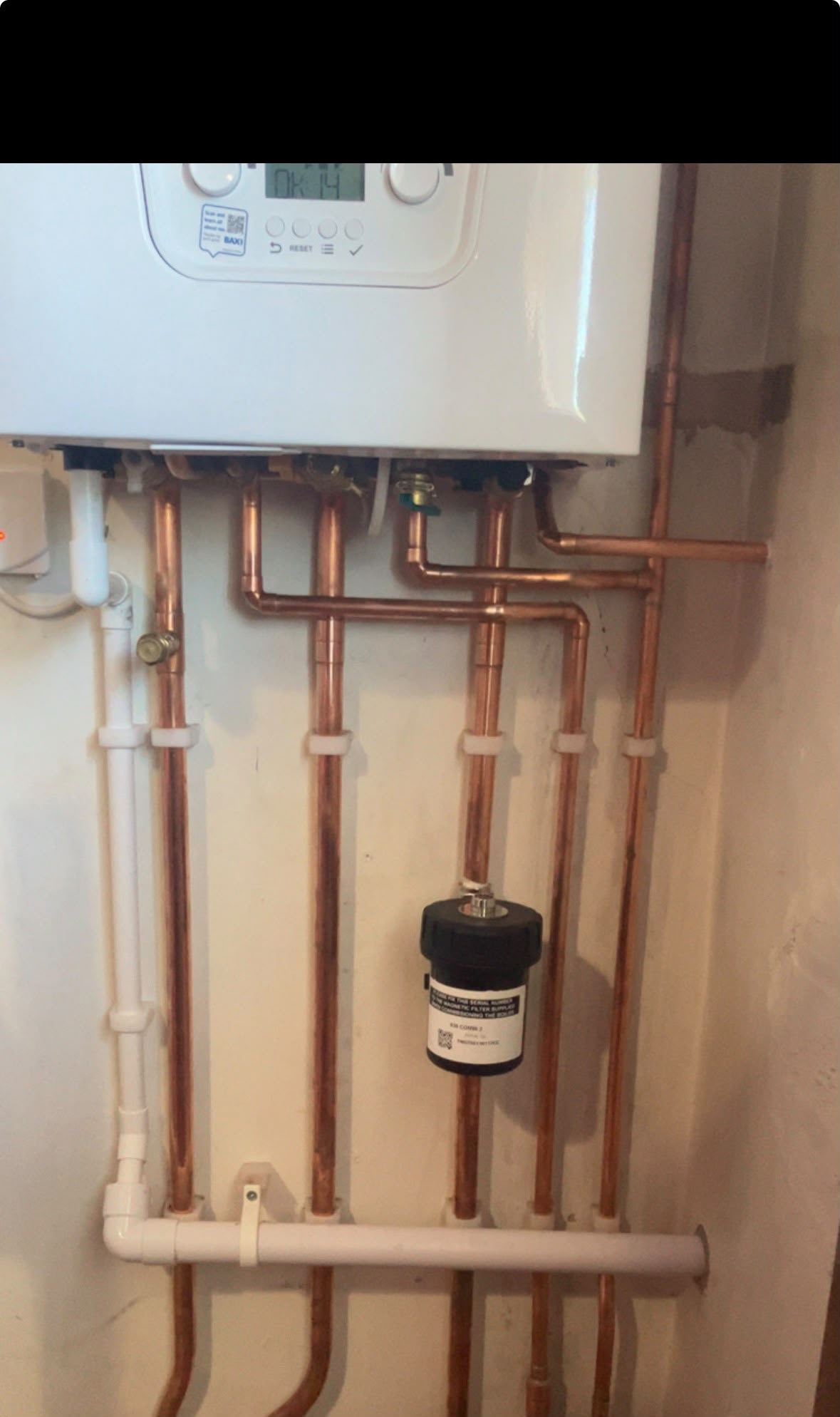 Tidy copper pipework beneath a wall-mounted boiler and magnetic filter